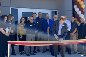 A group of people at a ribbon cutting